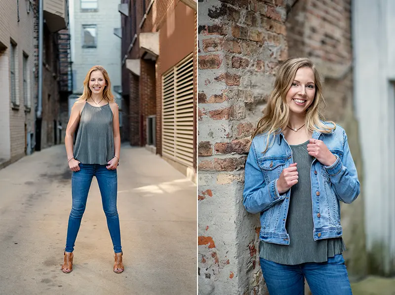 Stylish urban senior portraits of a high school girl in a denim jacket and green top posing confidently in a downtown Madison, WI alley with brick textures and natural light